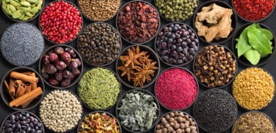 Fresh spices and herbs for food. Colorful condiments as background, top view. lot seasonings in cups, on table