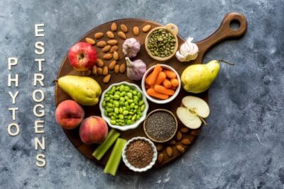 A wooden board topped with various foods that are high in phytoestrogens.